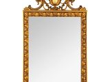 une image d'un miroir encadré d'or sur un fond blanc