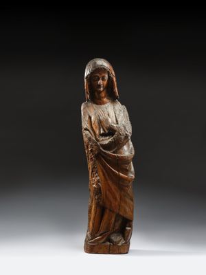 a wooden statue of a woman holding a child