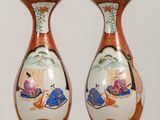 two vases that are sitting on a table
