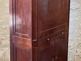 a wooden cabinet with a marble top on a brick floor