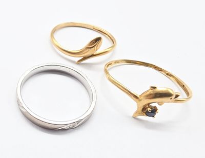 three gold and silver rings sitting on top of each other