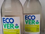 two bottles of ecover are sitting on a table next to a cup