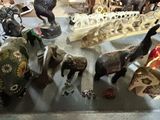 a lot of elephant figurines that are on the table
