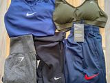 several pairs of women ' s nike sports clothing laid out on a wooden tray