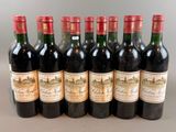 six bottles of wine are lined up in a row on a table