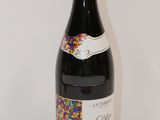the bottle of wine has sprinkles on it on the table