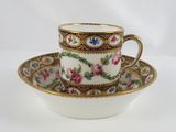 a cup and saucer with a floral design on it