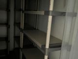 a room with shelves and a curtain in it