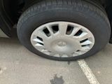 a tire that is sitting on the ground next to a car