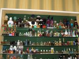 many different types of bottles on the shelves in this room