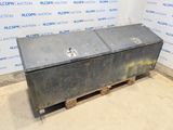 an old metal box sitting on top of a pallet in front of a wall