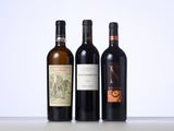 three bottles of wine are lined up on a table