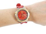 a person that is wearing a red watch on their wrist
