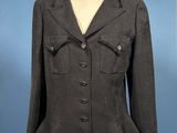 an image of a woman ' s jacket on a mannequin stand