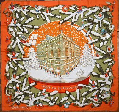une écharpe orange et verte avec l'image d'une maison dans une boule à neige