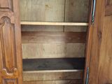 a wooden cabinet with a door open on the floor