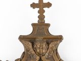 a gold clock with a cross on top of it