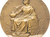 a close up of a gold medal with a woman sitting on a bench
