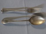 two spoons and a fork on a table