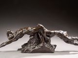 bronze sculpture of a woman and a dog on a rock