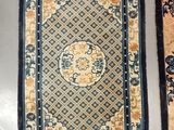 two oriental rugs on display on a table in a room