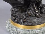 a bronze statue of a man and a dog on a rock