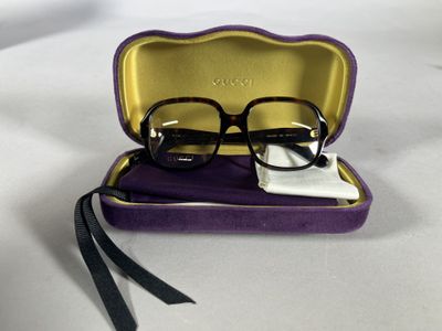 glasses in a case on a table with a white cloth