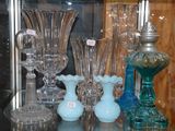 de nombreux vases en verre posés sur une étagère en verre