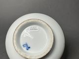 a white plate with a blue butterfly on it