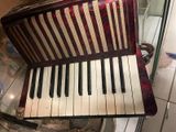 an old accordion sitting on top of a glass table in a room