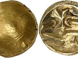 a close up of a gold coin with a woman on it
