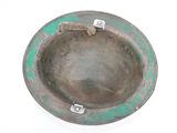 a metal ashtray with a green rim on a white surface