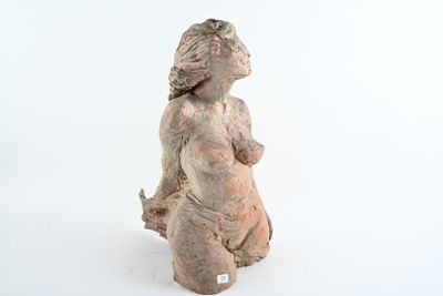 une statue représentant une femme assise sur une surface blanche