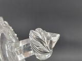a close up of a glass vase with a flower on it