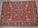 a red rug with a floral design on it