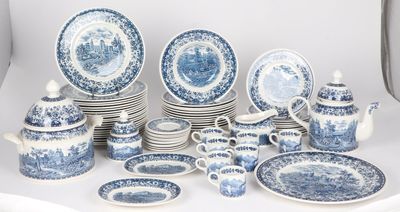 many blue and white plates and cups and saucers