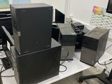 a computer desk with a lot of computer equipment on top of it