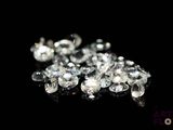 a lot of diamonds that are on a black surface