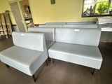 a couch and a chair in a room with a mirror on the wall