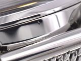 a close up of a silver watch with a chain around it