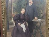 tableau représentant un homme et une femme posant pour une photo devant une table
