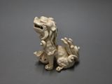 a figurine of a dog that is sitting on a table