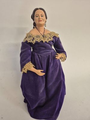 an image of a figurine of a woman in a purple dress