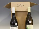 two bottles of wine sit in a cardboard box on a table