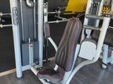 a gym room with a row of machines in it