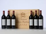 three bottles of wine sit in front of a wooden box