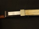 a close up of a knife on a black surface
