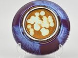 a purple plate with a blue and white design on it