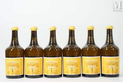 six bottles of beer are lined up in a row on a white surface