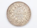 a close up of a coin on a white surface